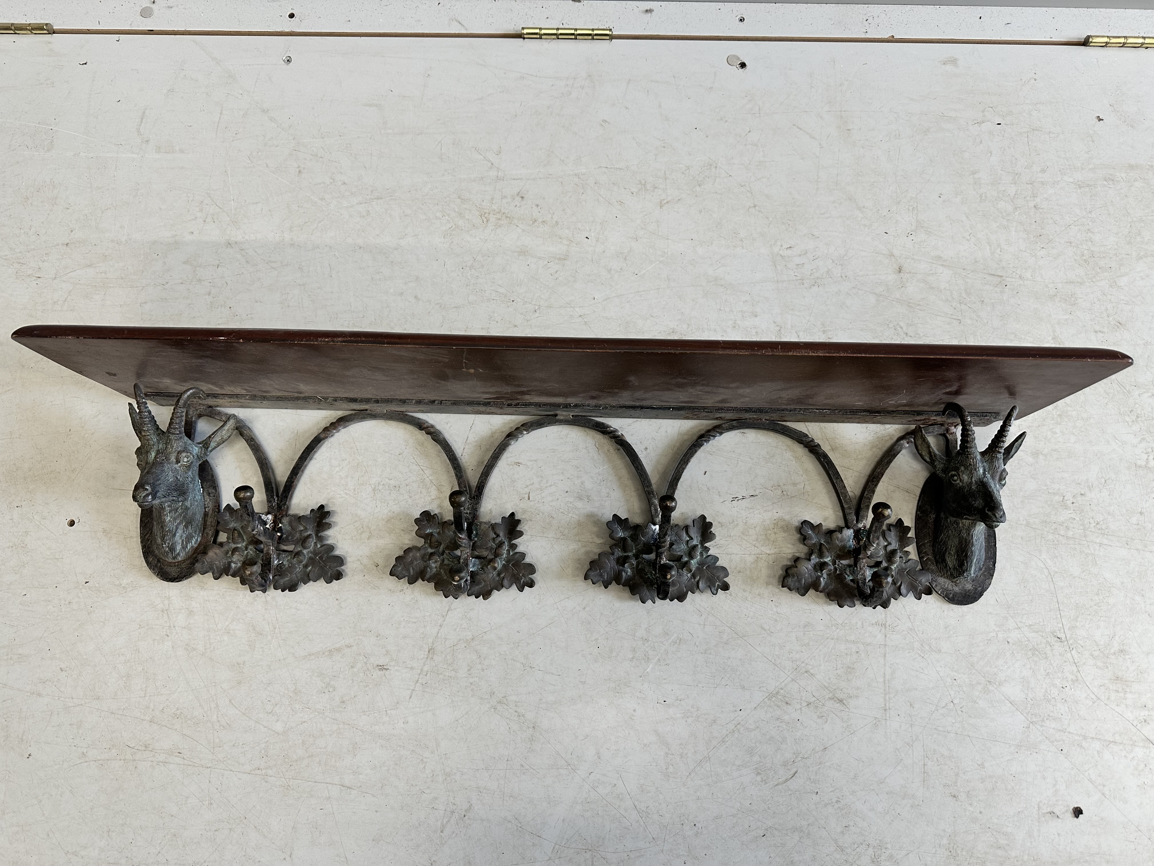 A Black Forest style mahogany and cast metal deer and acorn leaf hanging coat rack, width 97cm, depth 22cm, height 20cm